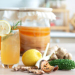 Homemade fermented raw kombucha tea, healthy natural probiotic drink and herbs ingredient, Scoby mushrooms to start the fermentation process in blur background